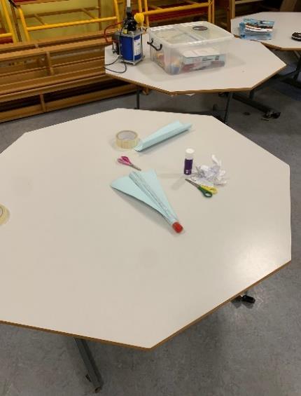 Aircraft paper models on tables.